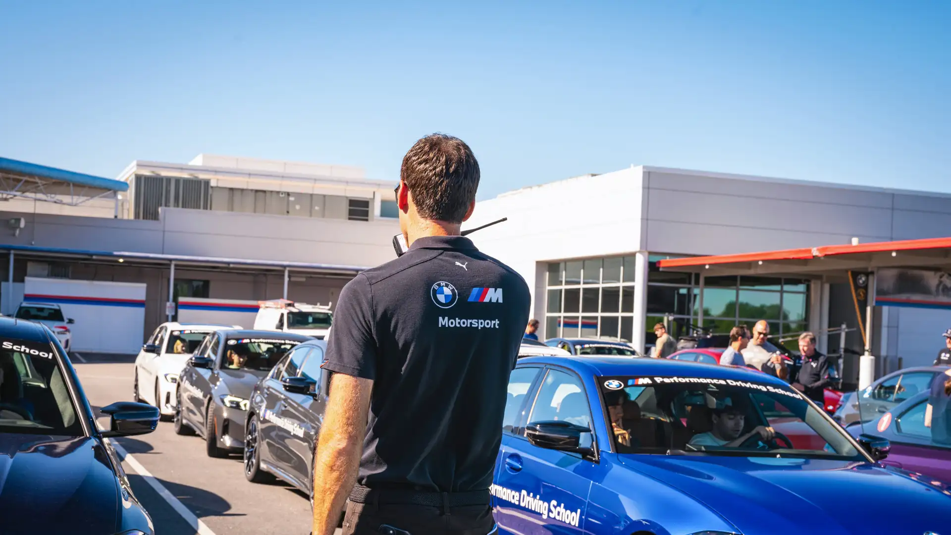 BMW driving instructor talking to walkie-talkie