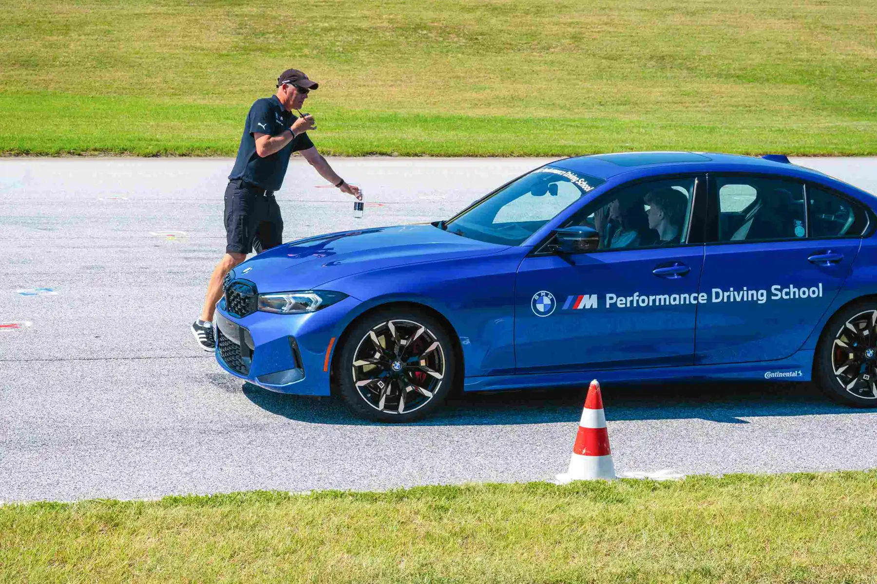 BMW driving instructor working with teens