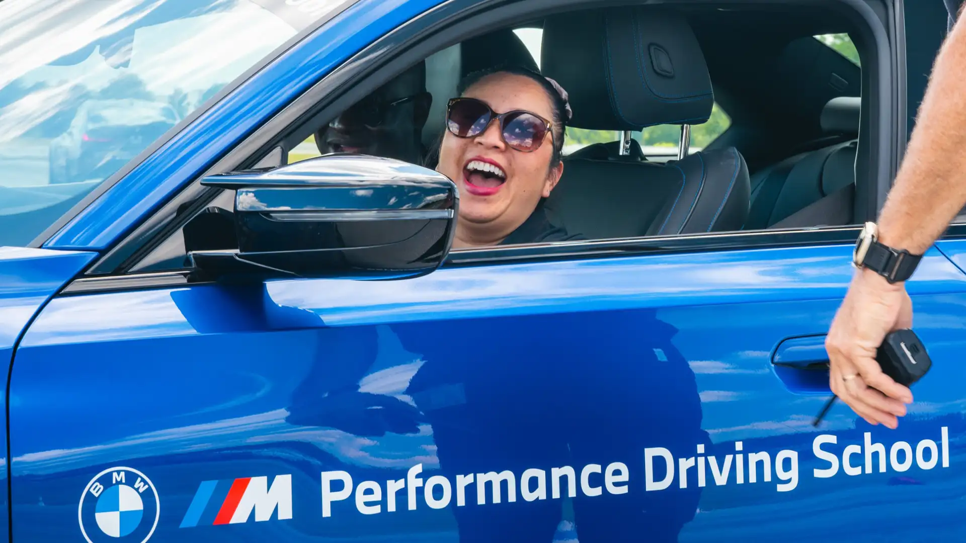 BMW driving student laughing