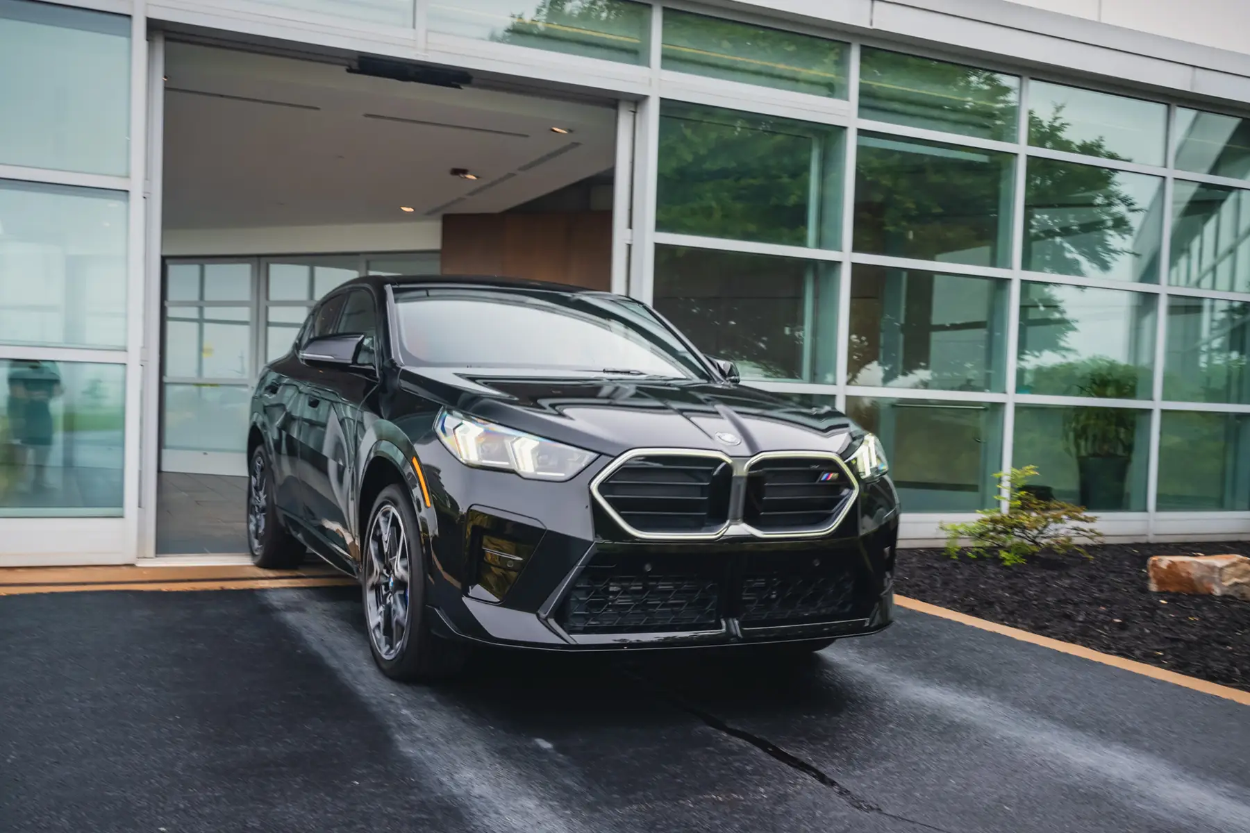 BMW new vehicle delivery pulling out of the dealership